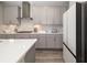 Kitchen with stainless steel appliances, gray cabinets and white backsplash at 12730 Oak Hill Way, Parrish, FL 34219
