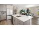 Modern kitchen features stainless appliances, gray cabinetry, spacious island, and wood-look floors at 12730 Oak Hill Way, Parrish, FL 34219
