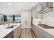 Modern kitchen with gray cabinets and island with seating that is next to the living room at 12730 Oak Hill Way, Parrish, FL 34219
