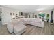 Open concept living room with large sectional sofa and view of kitchen and dining area offers ample space at 12730 Oak Hill Way, Parrish, FL 34219