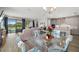 Open concept living and dining area overlooking water with sliding doors at 12730 Oak Hill Way, Parrish, FL 34219