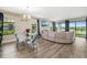 Spacious living area with lake view, dining area, and large sectional sofa create a comfortable space at 12730 Oak Hill Way, Parrish, FL 34219