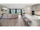 Open-concept living area with hardwood floors, modern furniture, and a view of the backyard lake at 12730 Oak Hill Way, Parrish, FL 34219
