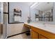 Well-lit bathroom featuring a vanity with a sink, a framed mirror, and a glass-enclosed shower at 13191 Siam Dr, Spring Hill, FL 34609