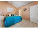 Spacious bedroom featuring tile floors, a comfortable bed, and ample natural light at 13191 Siam Dr, Spring Hill, FL 34609