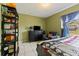 Cozy bedroom featuring a neutral-toned palette and a comfortable seating area at 13191 Siam Dr, Spring Hill, FL 34609