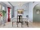 Formal dining room with lace tablecloth, charming chandelier, and beautiful mirror at 13191 Siam Dr, Spring Hill, FL 34609