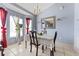 Elegant dining room featuring a chandelier, large mirror, and natural light at 13191 Siam Dr, Spring Hill, FL 34609