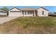 Charming single-story home with a manicured lawn and attached two-car garage at 13191 Siam Dr, Spring Hill, FL 34609