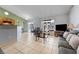Open-concept living area featuring tile flooring, natural light, and comfortable seating at 13191 Siam Dr, Spring Hill, FL 34609