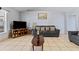 Bright living room with tile flooring, a large window, and comfortable gray sofas at 13191 Siam Dr, Spring Hill, FL 34609