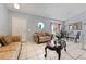 Bright living room featuring tile floors, a bay window and elegant furnishings at 13191 Siam Dr, Spring Hill, FL 34609