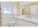 Bathroom with white vanity, quartz countertop, and white tile bathtub at 13911 Briardale Ln, Tampa, FL 33618