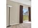 Bedroom featuring hardwood-style flooring, large window, and modern floor lamp at 13911 Briardale Ln, Tampa, FL 33618