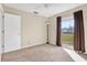 Neutral bedroom with a window overlooking the front of the property and carpeted floors at 13911 Briardale Ln, Tampa, FL 33618