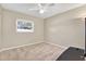 Cozy bedroom with neutral carpet, ceiling fan, and bright window overlooking yard at 13911 Briardale Ln, Tampa, FL 33618