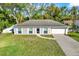 Attractive single-story home with well-manicured lawn, and a two-car garage at 13911 Briardale Ln, Tampa, FL 33618