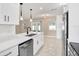 Modern kitchen boasts stainless steel appliances, white cabinetry, quartz countertops, and an open layout at 13911 Briardale Ln, Tampa, FL 33618