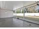 Enclosed patio with concrete floors looking out onto a fenced backyard with grass and storage shed at 13911 Briardale Ln, Tampa, FL 33618