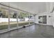 Enclosed patio with concrete floors looking out onto a fenced backyard with grass and storage shed at 13911 Briardale Ln, Tampa, FL 33618