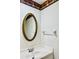 The bathroom has an oval mirror and an intricate border near the ceiling at 1620 58Th Ave. S. # 1, St Petersburg, FL 33712