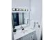 This bathroom features a white vanity with a mirror and brushed metal hardware at 1620 58Th Ave. S. # 1, St Petersburg, FL 33712