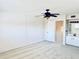 This large bedroom has neutral carpeting, a ceiling fan, and a stairway entrance at 1620 58Th Ave. S. # 1, St Petersburg, FL 33712