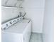 Laundry room features include tile flooring and white appliances at 1620 58Th Ave. S. # 1, St Petersburg, FL 33712