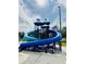 Large spiraling blue slide on a blue and metal play structure on a concrete surface under a bright sky at 1620 58Th Ave. S. # 1, St Petersburg, FL 33712