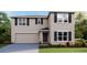 Charming two-story home features a two-car garage, neutral stucco exterior, and well-manicured lawn at 1706 Tahitian Sunrise Dr, Plant City, FL 33565