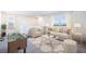 Spacious bonus living room complete with a fun game of foosball, cozy couches, and bright, sunlit windows at 1706 Tahitian Sunrise Dr, Plant City, FL 33565