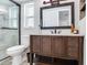 Modern bathroom featuring vanity with drawers, framed mirror, and glass enclosed shower at 1826 Asbury Dr, Clearwater, FL 33765