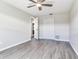 Bedroom features a ceiling fan, wood-look floors, and double door closet at 1826 Asbury Dr, Clearwater, FL 33765