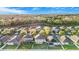Neighborhood aerial shot with manicured lawns and a nearby lake under a clear blue sky at 20427 Carolina Cherry Ct, Tampa, FL 33647