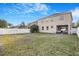 Expansive backyard with privacy fence, lush lawn, and a covered patio area at 20427 Carolina Cherry Ct, Tampa, FL 33647