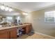 Bright bathroom with double vanity, granite countertops, and a large mirror at 20427 Carolina Cherry Ct, Tampa, FL 33647