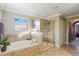 Spa-like bathroom featuring a soaking tub and separate glass-enclosed shower at 20427 Carolina Cherry Ct, Tampa, FL 33647