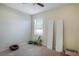 This is an empty bedroom featuring a ceiling fan, a window with blinds and neutral carpet at 20427 Carolina Cherry Ct, Tampa, FL 33647