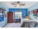 Bright bedroom features a ceiling fan, large window, and a cozy sleeping space at 20427 Carolina Cherry Ct, Tampa, FL 33647