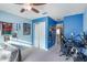 Blue bedroom featuring a built-in closet, ceiling fan, and desk area at 20427 Carolina Cherry Ct, Tampa, FL 33647