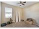 An empty bedroom featuring a ceiling fan, a window with blinds and neutral carpet at 20427 Carolina Cherry Ct, Tampa, FL 33647