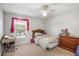Bedroom with a bed, desk, dresser, and window with pink decor offering a functional space at 20427 Carolina Cherry Ct, Tampa, FL 33647