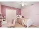 Bedroom featuring pink walls, white furniture, ceiling fan, and carpet flooring providing a calm atmosphere at 20427 Carolina Cherry Ct, Tampa, FL 33647