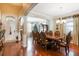 Formal dining room with hardwood floors, a large table, and elegant chairs, perfect for entertaining at 20427 Carolina Cherry Ct, Tampa, FL 33647