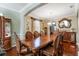 Elegant dining room with a large wooden table, seating for eight, and a decorative china cabinet at 20427 Carolina Cherry Ct, Tampa, FL 33647