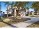 Charming two-story home with a well-manicured lawn and palm trees, showcasing curb appeal at 20427 Carolina Cherry Ct, Tampa, FL 33647