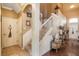Spacious foyer with stairs, decorated table with decor, and light tile and wood flooring at 20427 Carolina Cherry Ct, Tampa, FL 33647