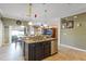 Well-lit kitchen featuring granite countertops, stainless steel dishwasher, a sink, and dark wood cabinets at 20427 Carolina Cherry Ct, Tampa, FL 33647