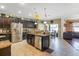 Spacious open kitchen with stainless appliances, granite countertops, and an island with a sink at 20427 Carolina Cherry Ct, Tampa, FL 33647