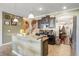 Modern kitchen featuring an island with granite countertops, dark cabinetry, and stainless steel appliances at 20427 Carolina Cherry Ct, Tampa, FL 33647